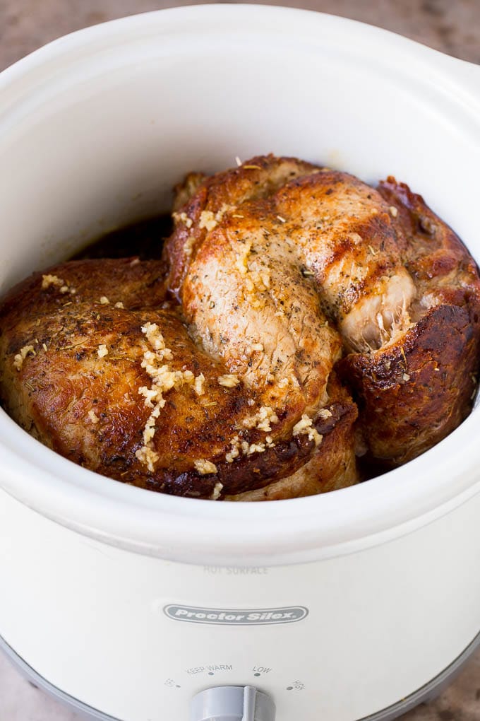 Pork in a slow cooker coated in sauce.
