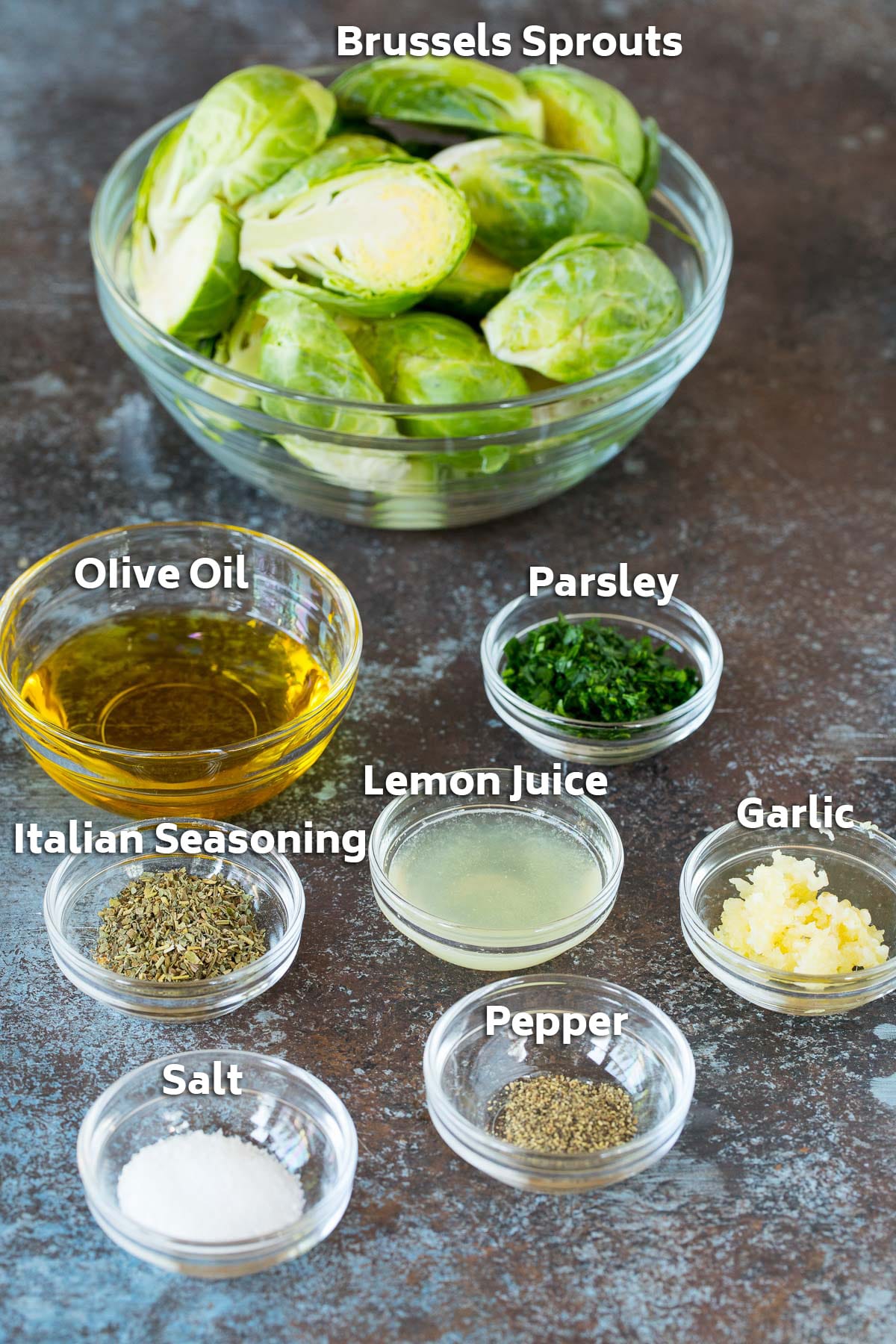 Bowls of ingredients including brussels sprouts, olive oil, lemon juice and herbs.