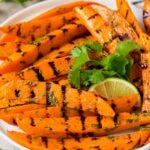 A plate of grilled sweet potatoes topped with cilantro lime dressing.