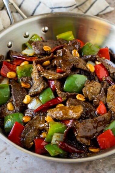 Kung pao beef with peppers and peanuts in a saute pan.