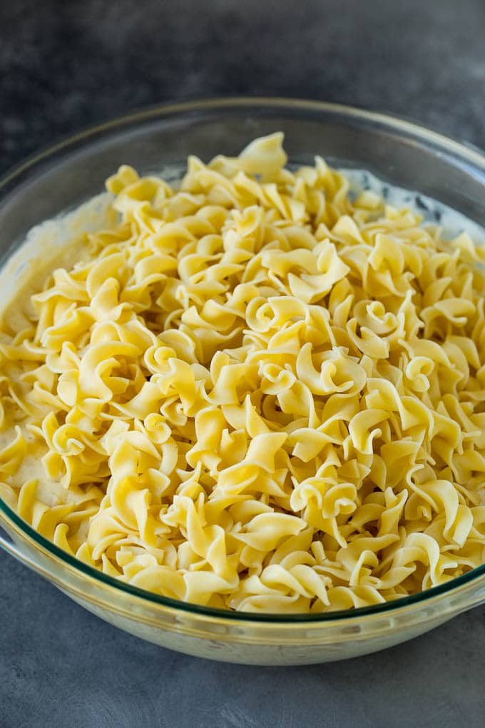 A bowl of cream cheese, cottage cheese, sour cream and egg noodles.