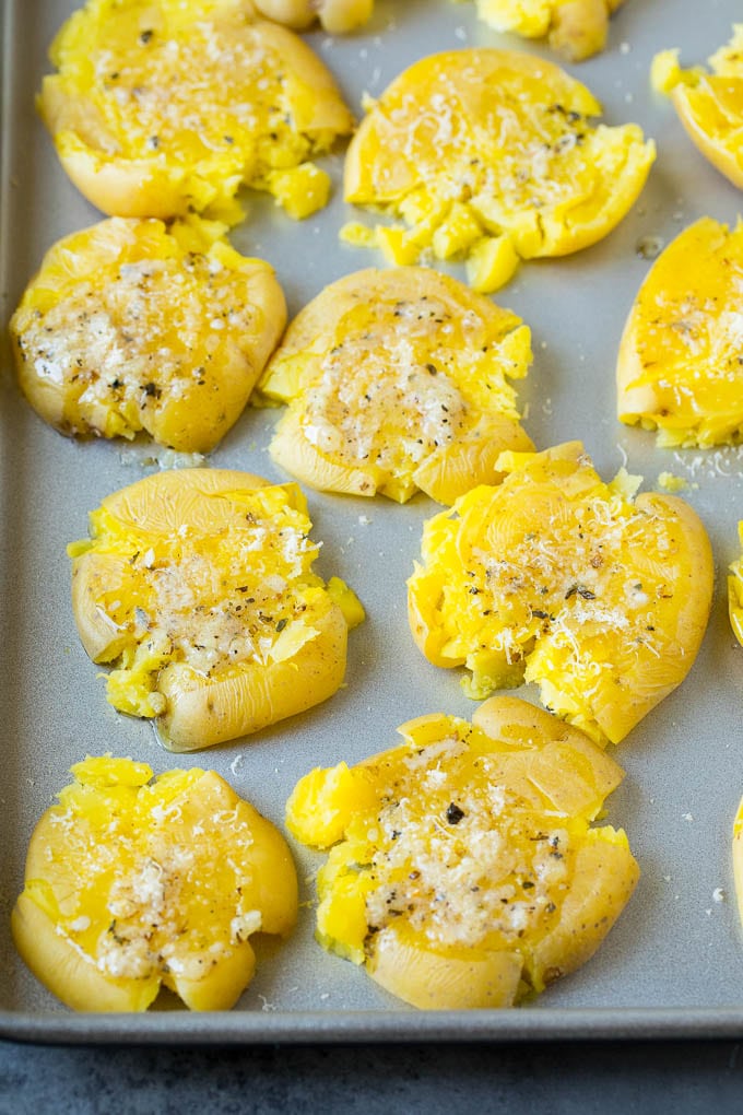 Flattened potatoes topped with garlic butter, herbs and cheese.