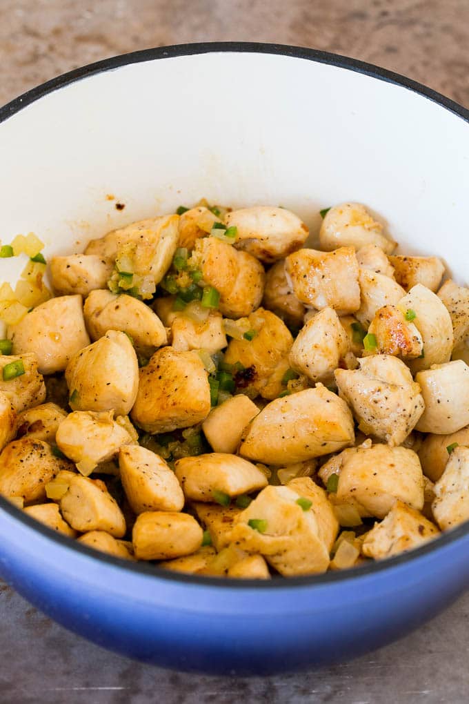 This white chicken chili is a creamy blend of chicken, chilies, beans and spices, all simmered together Sauteed chicken, onions and jalapenos in a pot.
