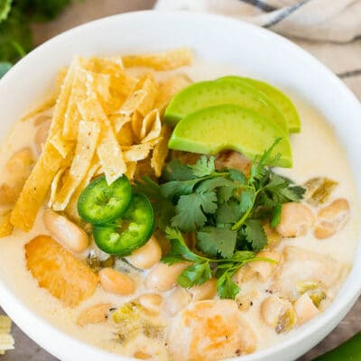 White chicken chili topped with tortilla strips, cilantro and avocado.