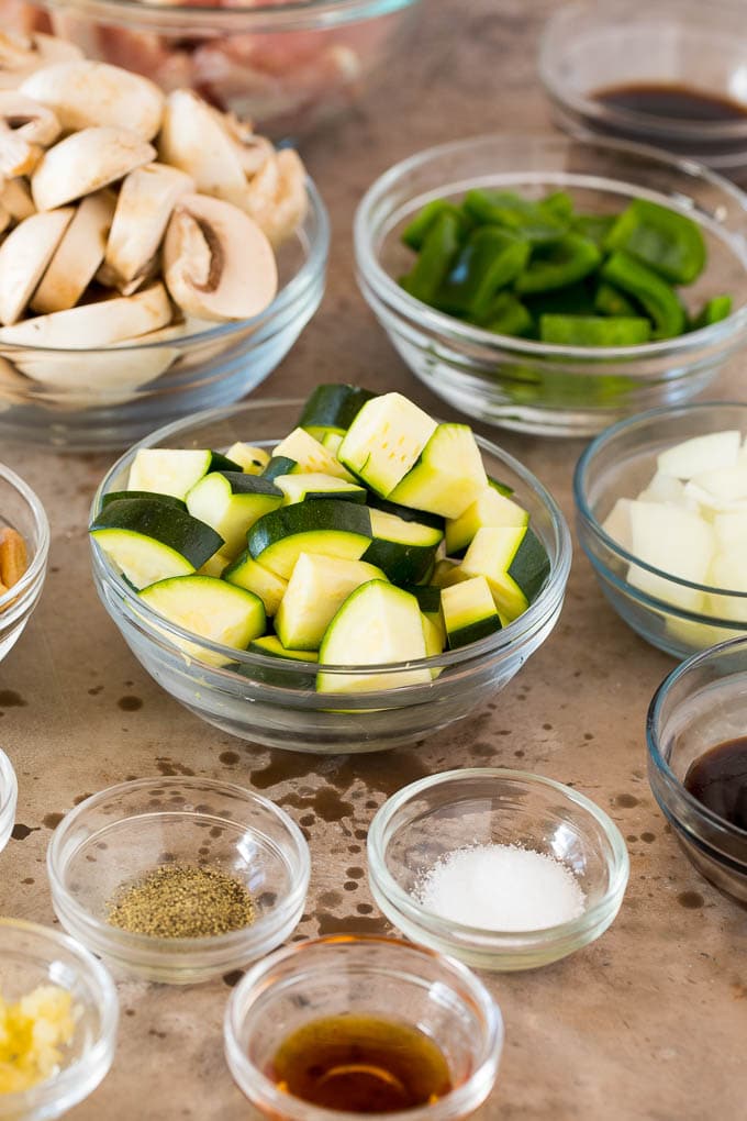 Bowls of diced vegetables and sauce ingredients.