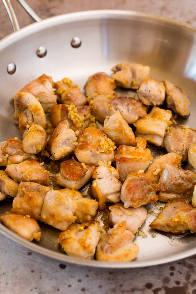 This almond chicken is a stir fry of chicken thigh pieces, assorted vegetables and crunchy almonds, all tossed in a savory sauce. Seared chicken with garlic and ginger.