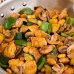 A pan of almond chicken stir fry with vegetables.