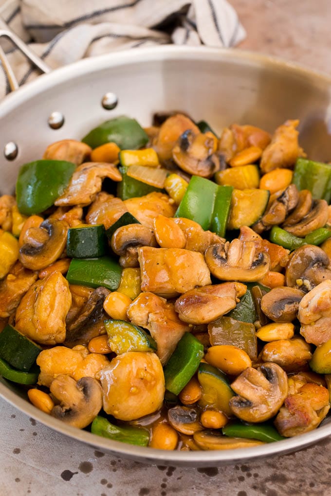 A pan of almond chicken stir fry with vegetables.