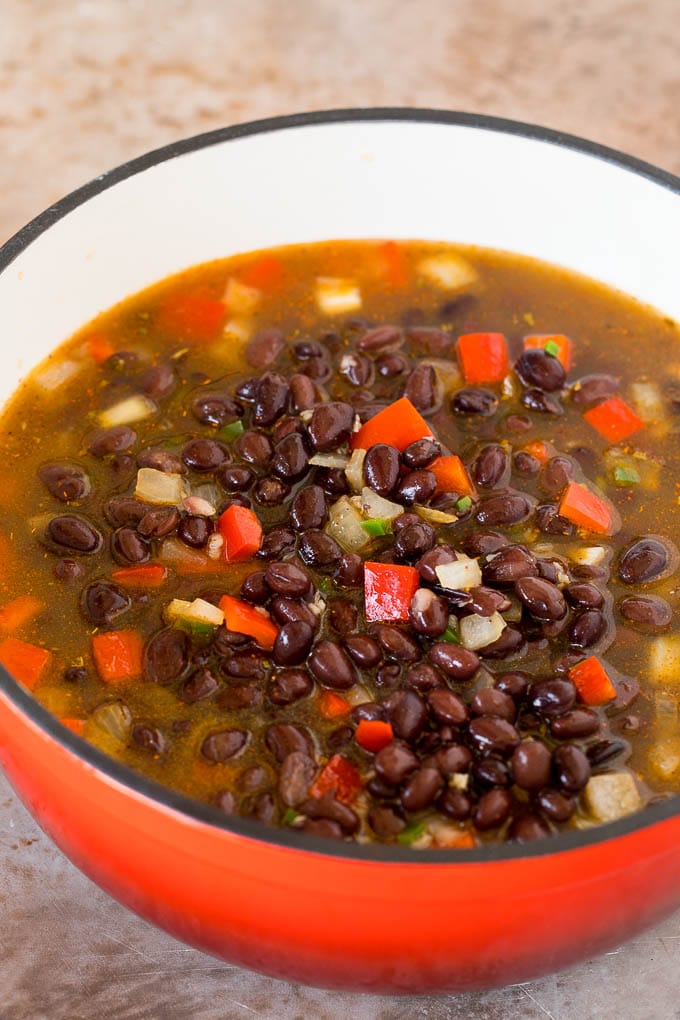 This black bean soup is a zesty blend of beans and vegetables, simmered together to make a thick and hearty meal. Add your favorite toppings and you'll have an easy and healthy dinner option that's sure to get rave reviews! A pot of beans, broth and vegetables.