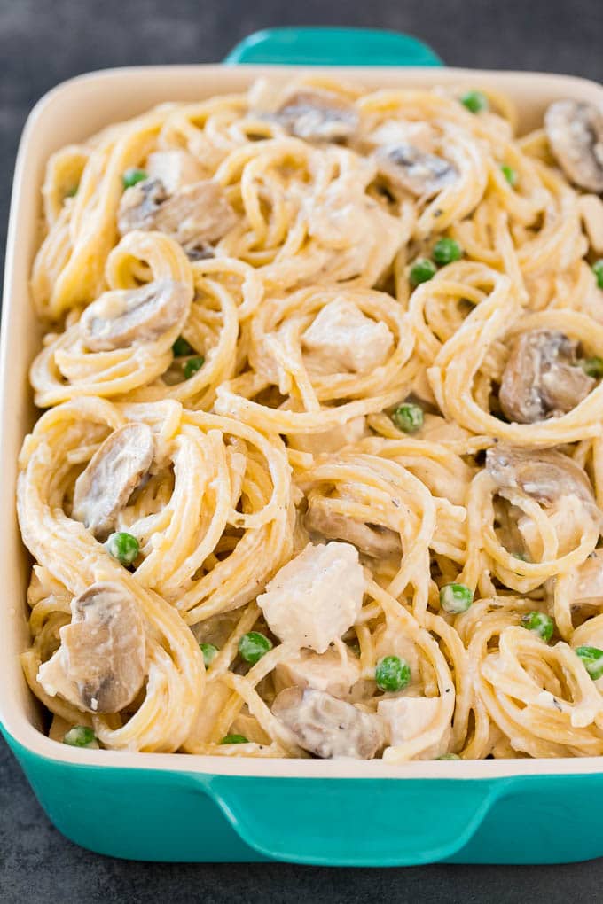 Pasta,chicken and vegetables in creamy sauce in a baking dish.