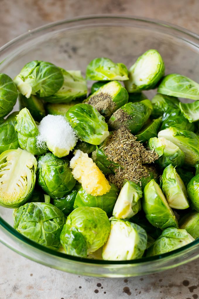 A bowl of Brussels sprouts with garlic, herbs, olive oil and spices.