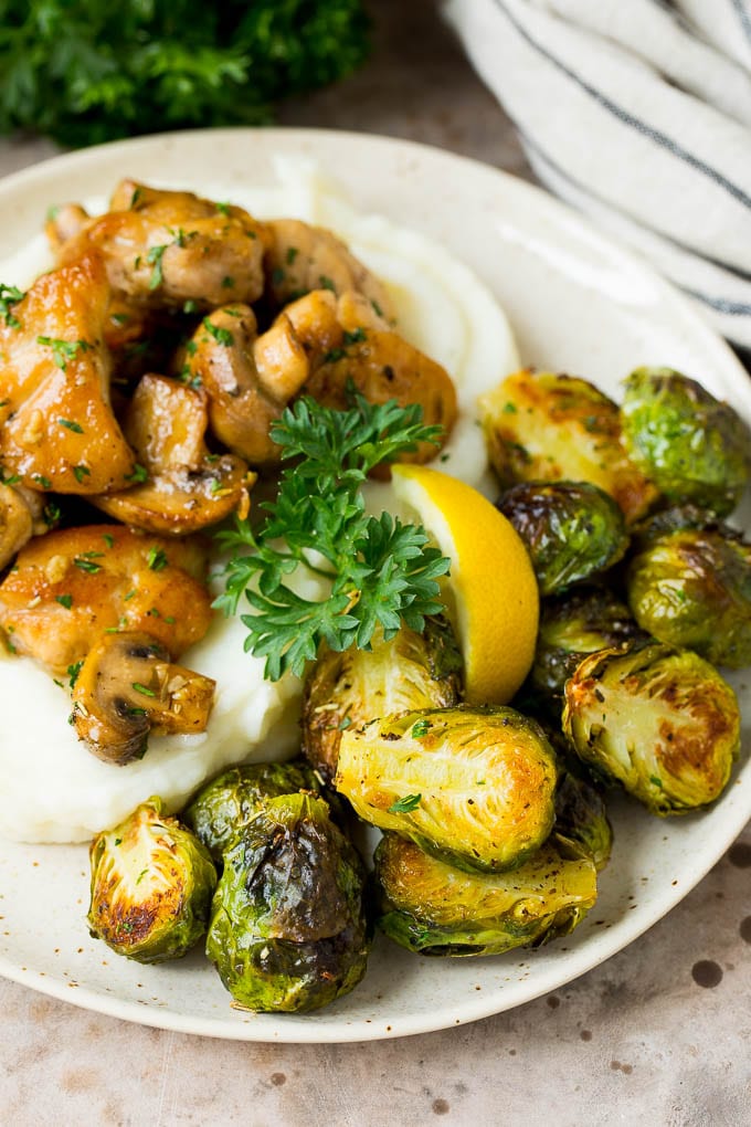 Crispy Brussels sprouts served with mashed potatoes and garlic chicken.