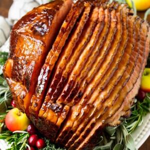 A ham covered in homemade ham glaze, garnished with fruit.