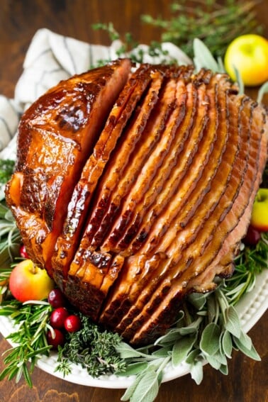 A ham covered in homemade ham glaze, garnished with fruit.