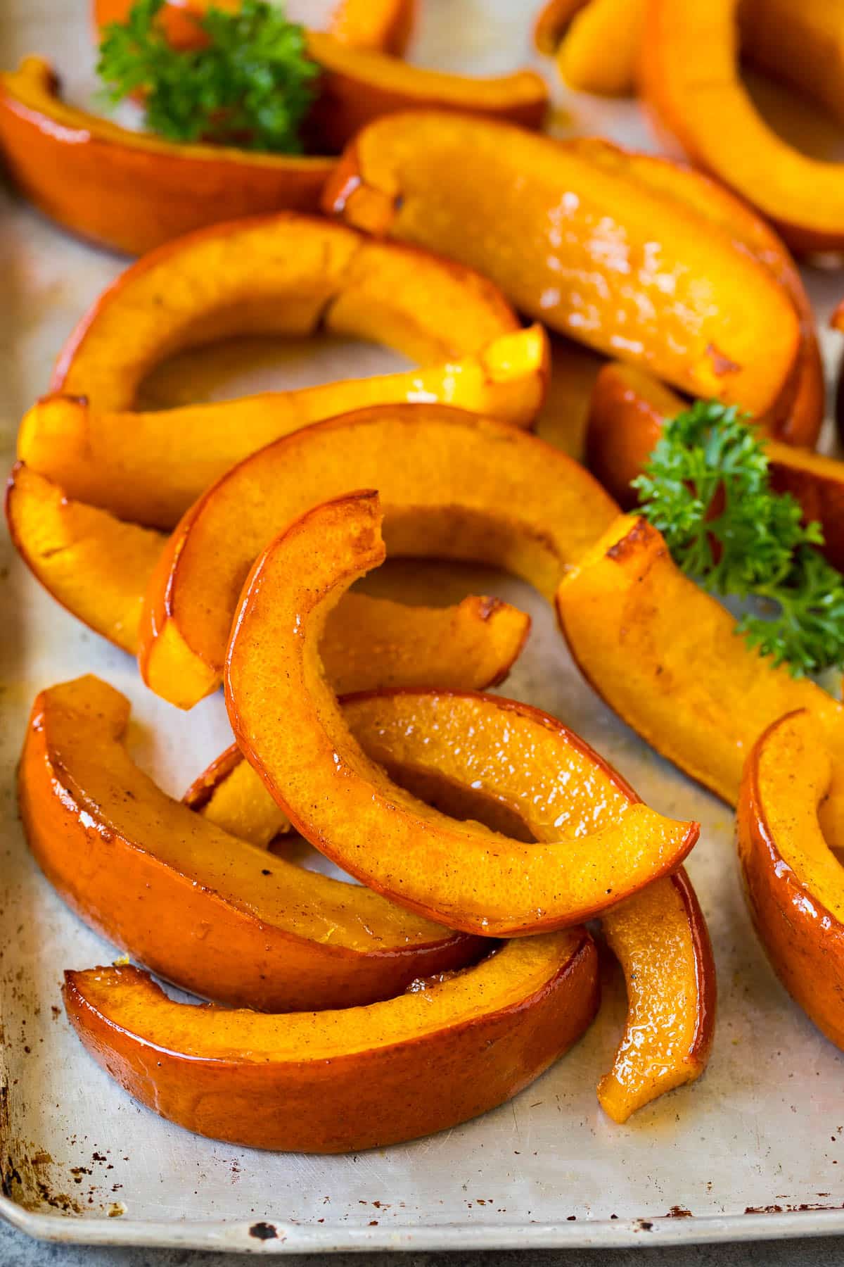 Roasted pumpkin on a sheet pan with parsley.