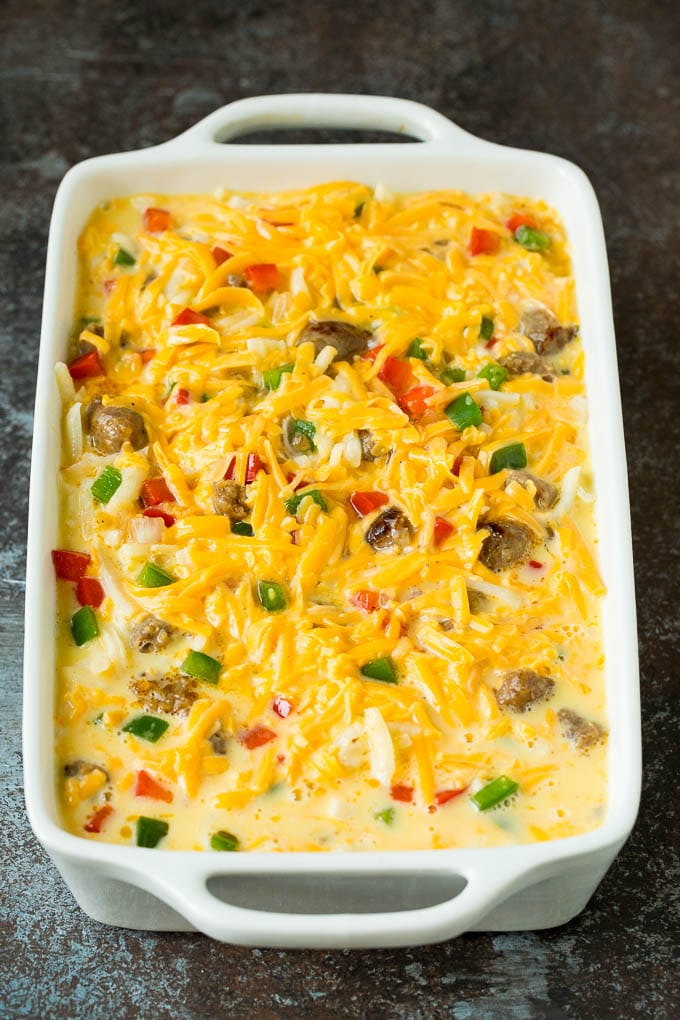 A dish filled with eggs, cheese and sausage.