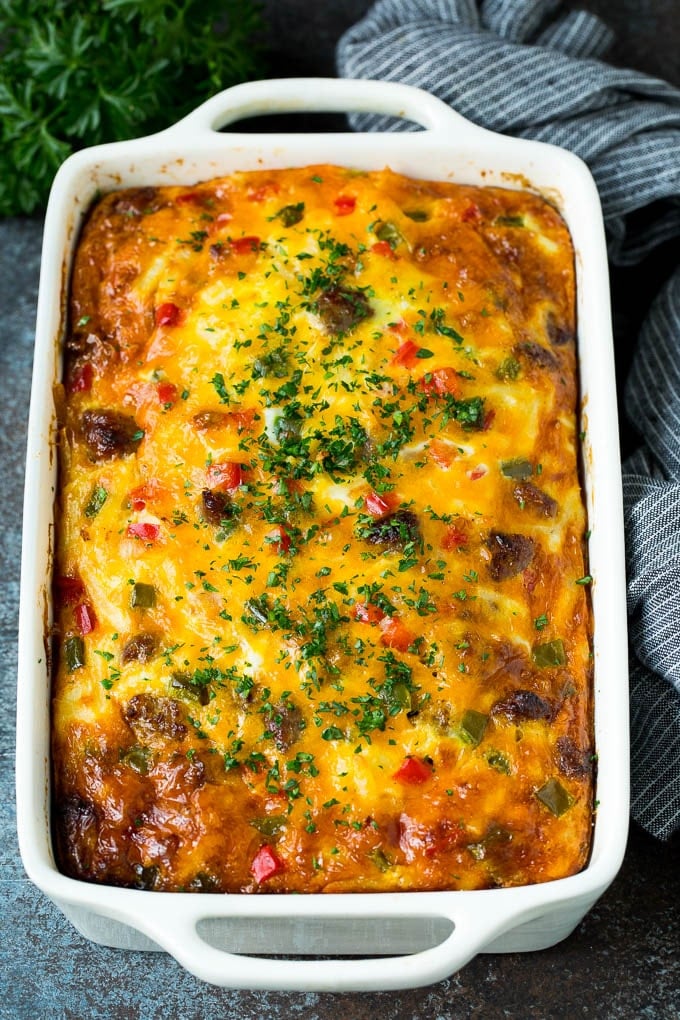 Sausage casserole with peppers and onions, topped with parsley.