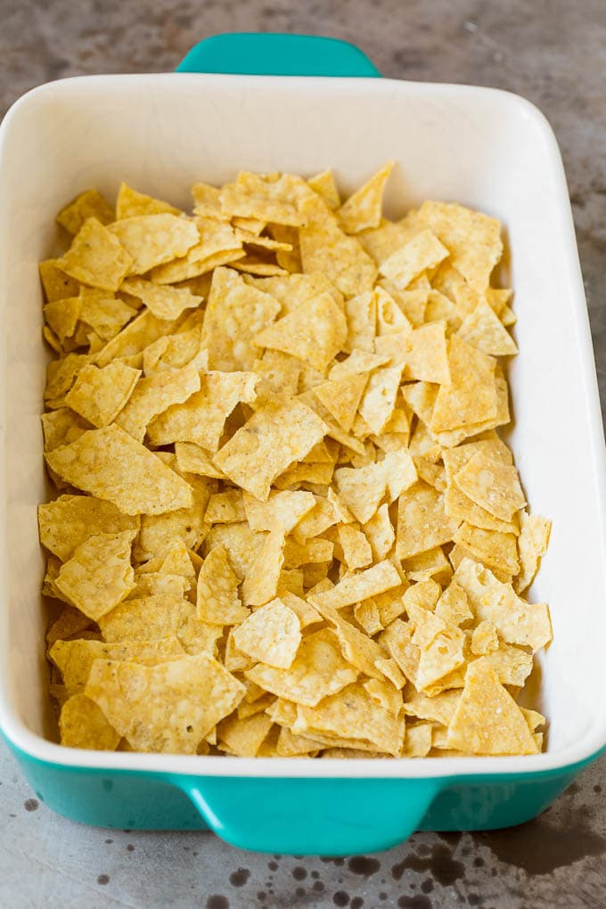 Crushed tortilla chips in a baking dish.