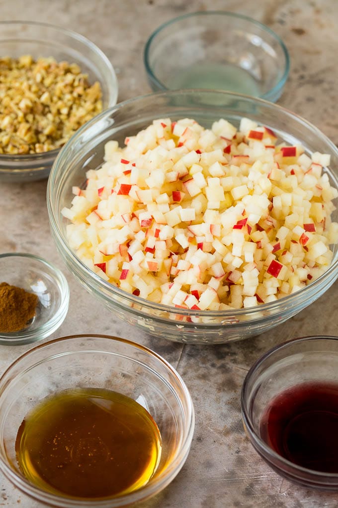 Bowls of chopped apples, honey, wine and cinnamon.