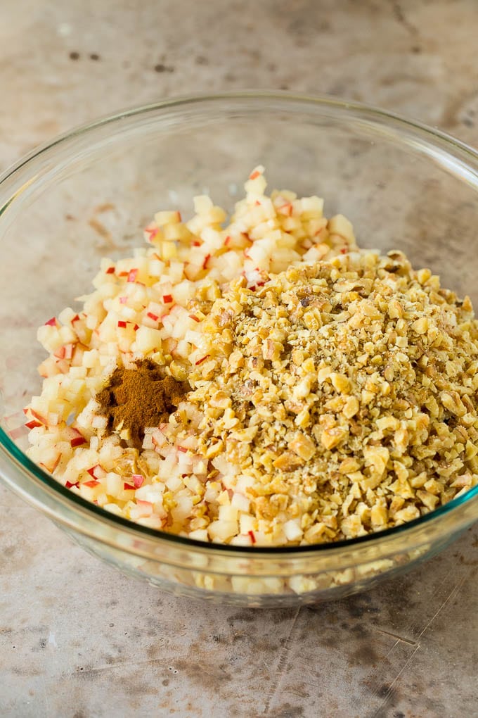 Apples, wine, cinnamon and honey all in a bowl.