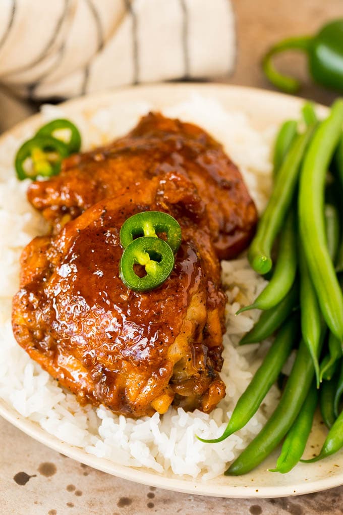 Chicken adobo served with rice and green beans.