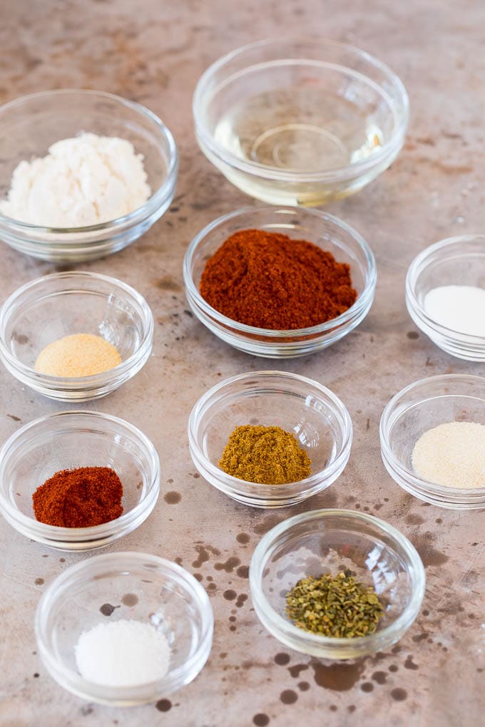 Small glass bowls of herbs and spices.