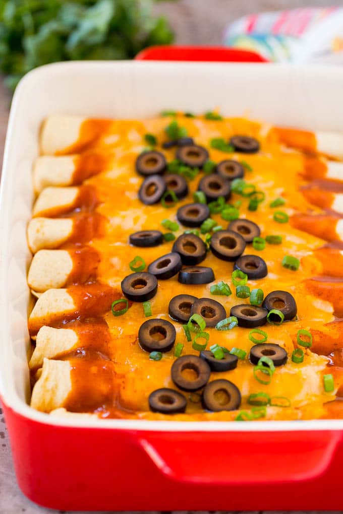 A tray of cheese enchiladas made with homemade enchilada sauce.