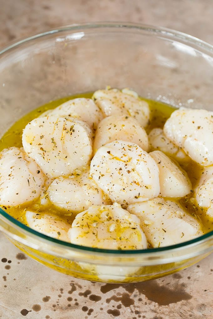 Scallops coated in garlic and herb marinade.