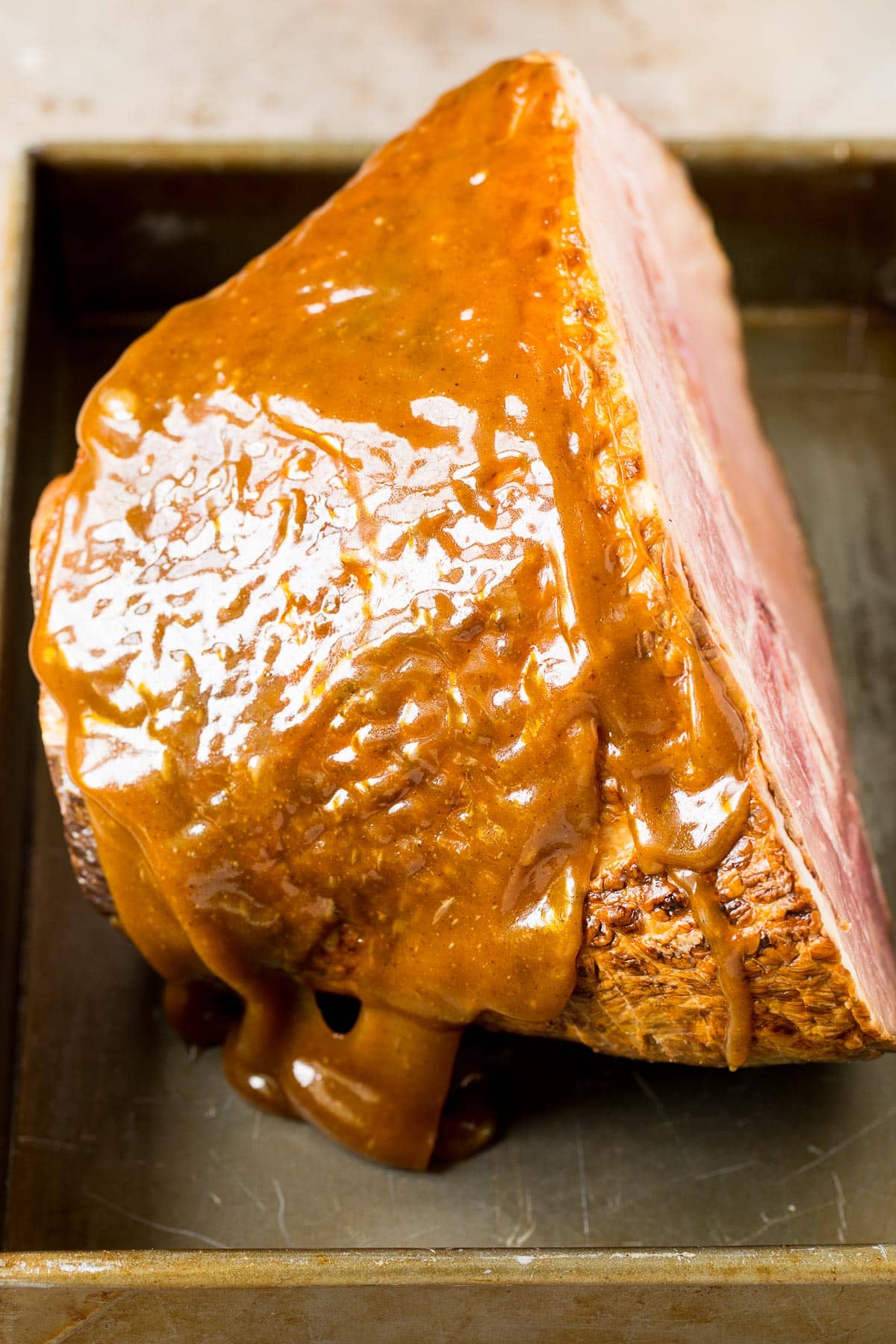 Pork in a baking pan with glaze on it.