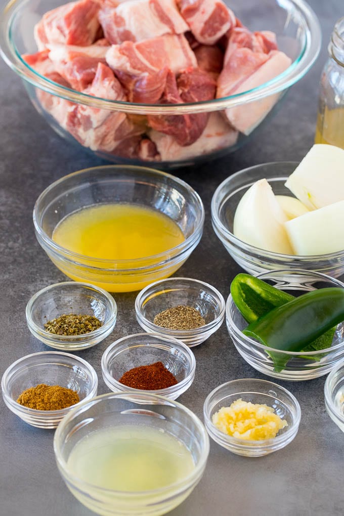 Bowls of ingredients including pork, spices, onion and jalapeno.