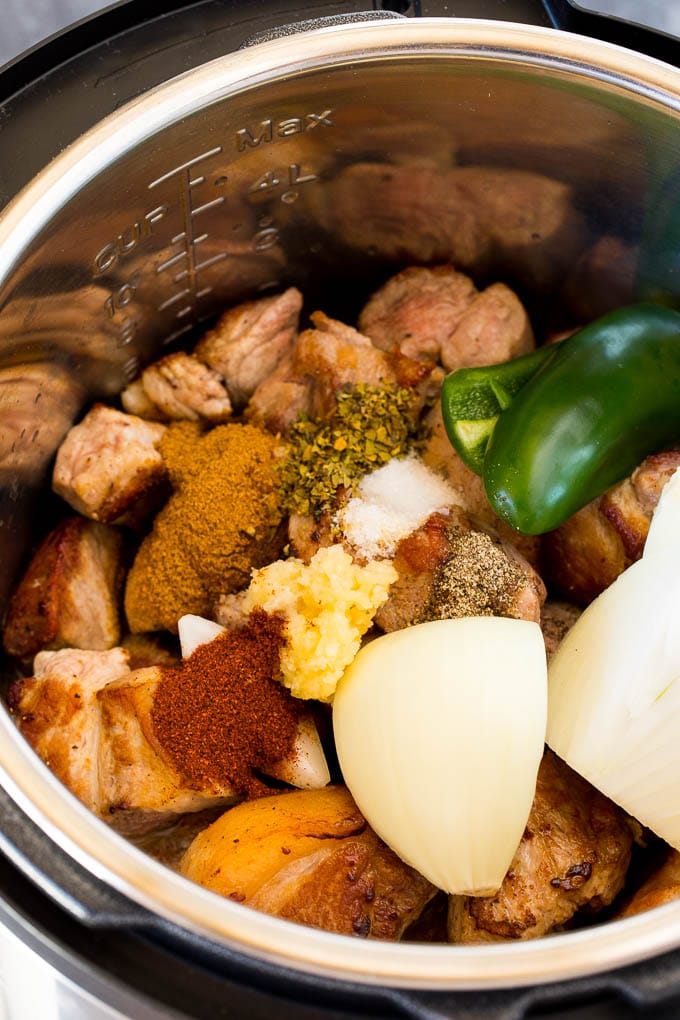 Pork, garlic, spices, jalapeno and onion in a pressure cooker.