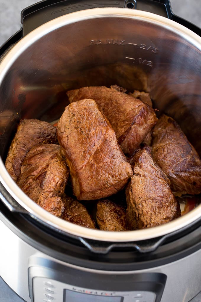 Short ribs seared in a pressure cooker.