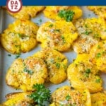 These smashed potatoes are baby potatoes that are boiled until tender, then smashed flat, topped with garlic and herb butter, and roasted until crispy and browned.