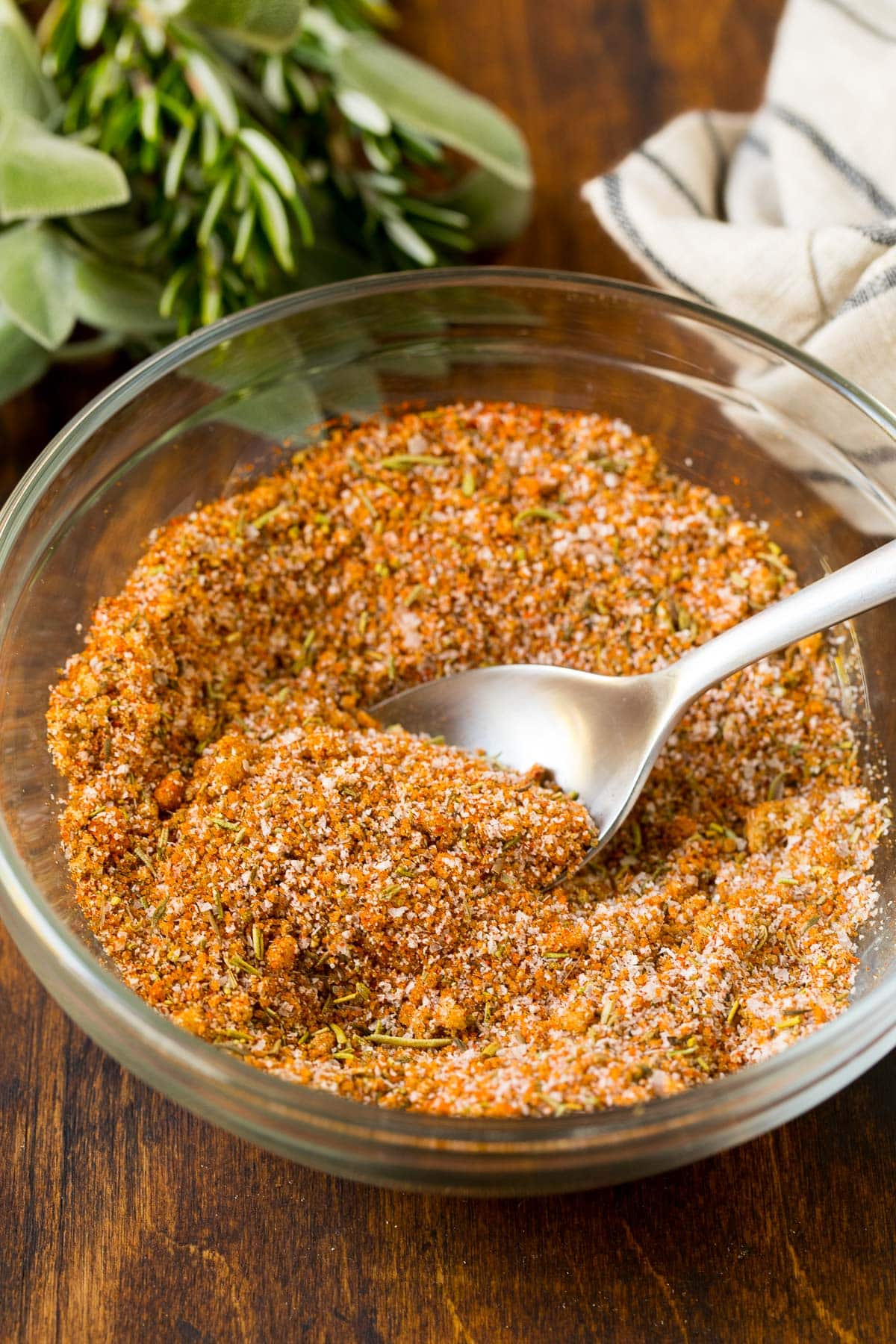 A bowl of spice mix with a spoon in it.