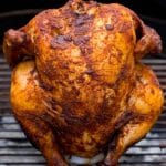 A beer can chicken coated in seasonings and grilled until done.