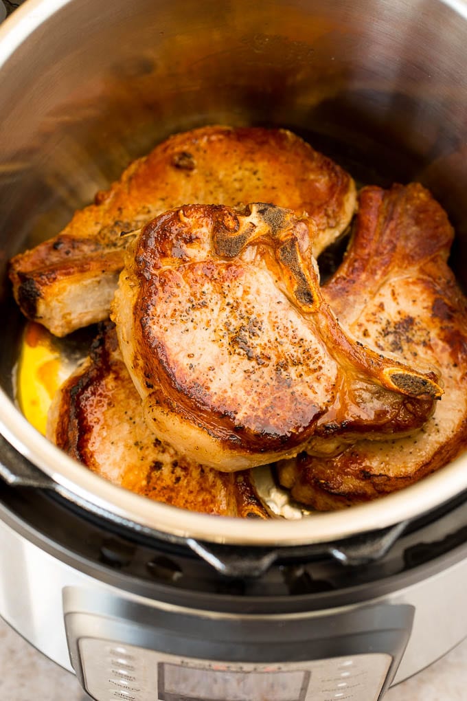 Seared pork chops in a pressure cooker.