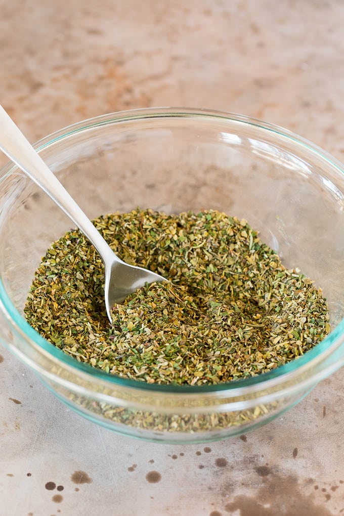 A bowl of seasoning blend with a spoon in it.