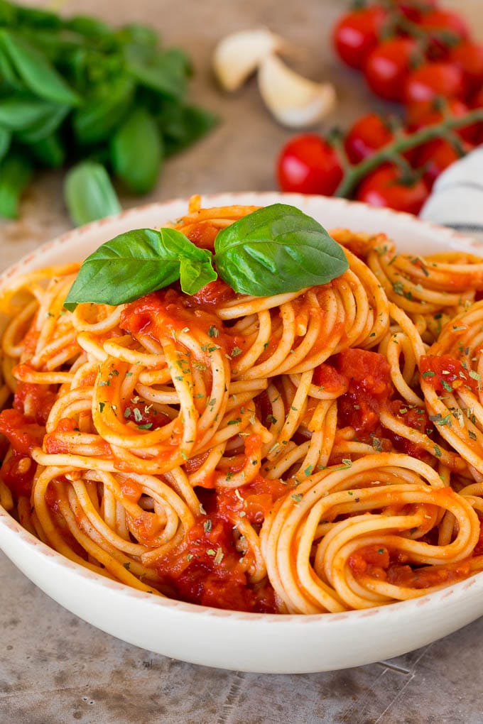 Italian seasoning sprinkled over a bowl of spaghetti.