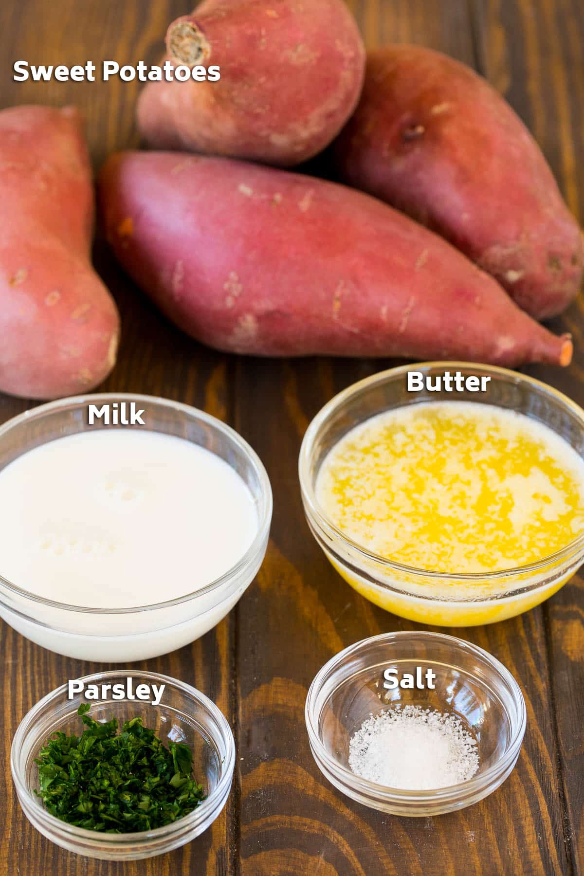 Ingredients including milk, butter, salt and parsley in small bowls.