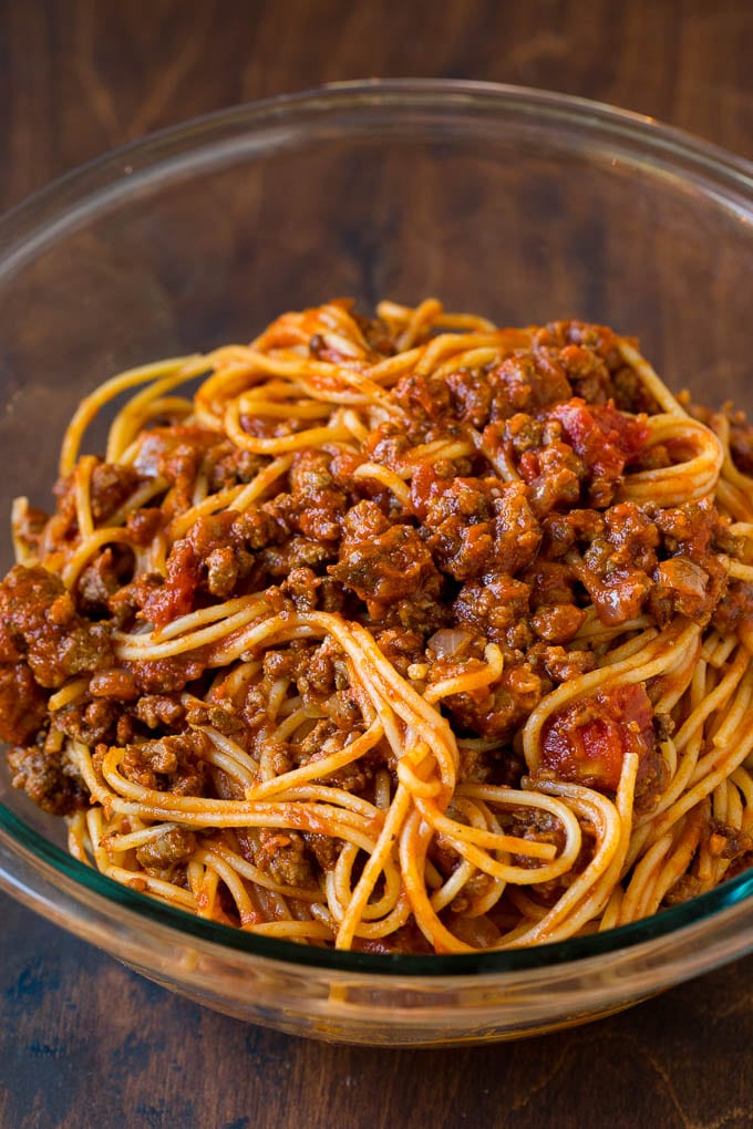 Spaghetti tossed with meat sauce in a bowl.