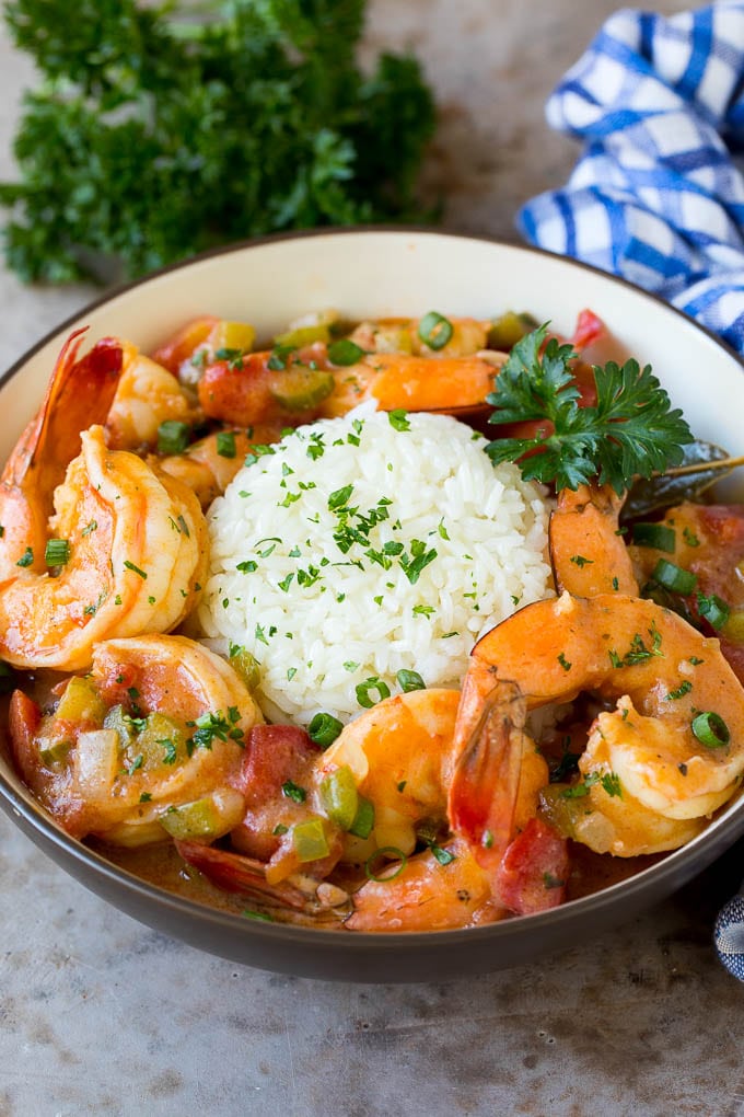 A bowl of shrimp etouffee served with rice.