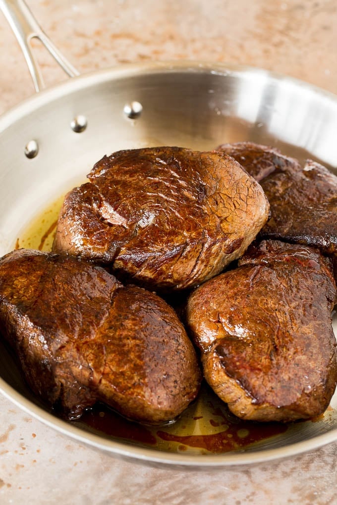 Seared steak in a pan.