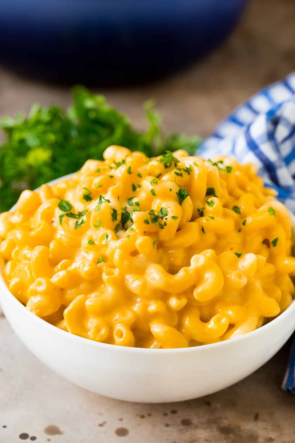 A bowl of stovetop mac and cheese topped with parsley.