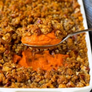 A spoon serving up a portion of sweet potato souffle.