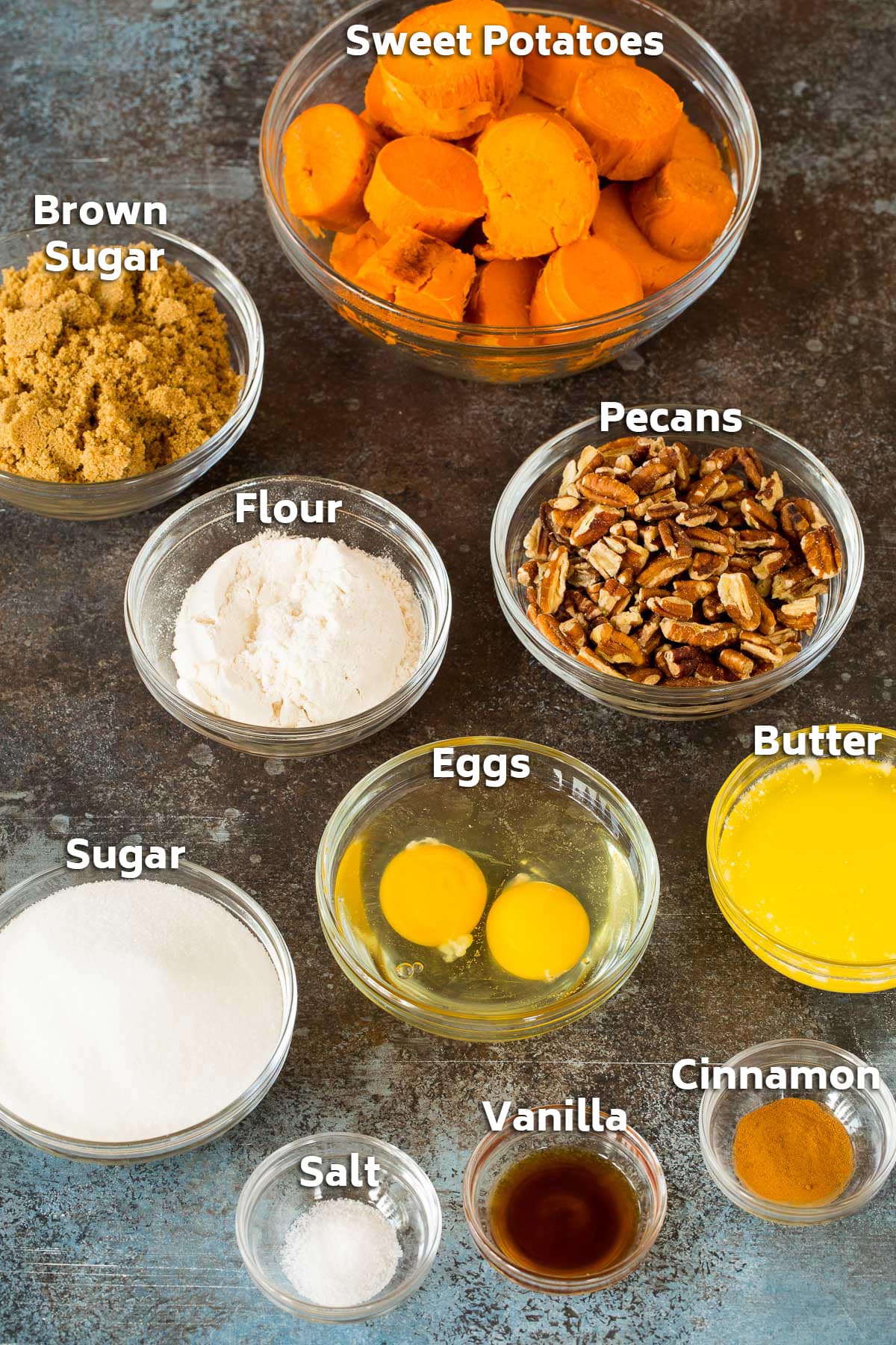 Bowls of ingredients including cooked sweet potatoes, sugar, butter and pecans.