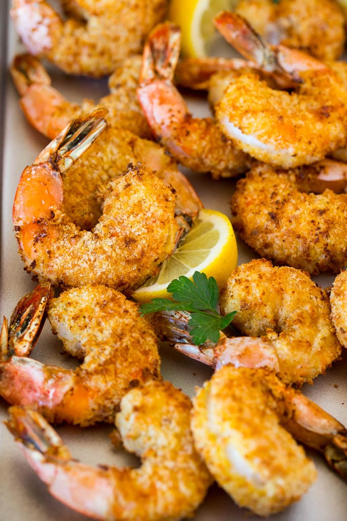 Air fryer shrimp garnished with lemon and parsley.