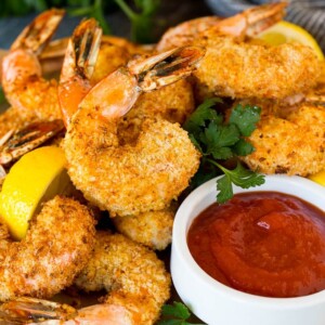 A plate of air fryer shrimp served with cocktail sauce.