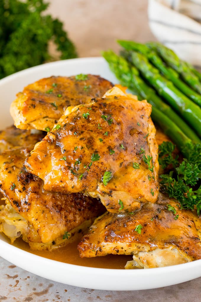 Instant Pot chicken thighs with gravy, served with asparagus.