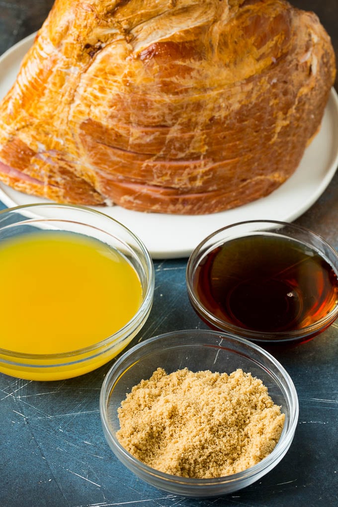 Ingredients including pineapple juice, maple syrup and brown sugar in bowls.