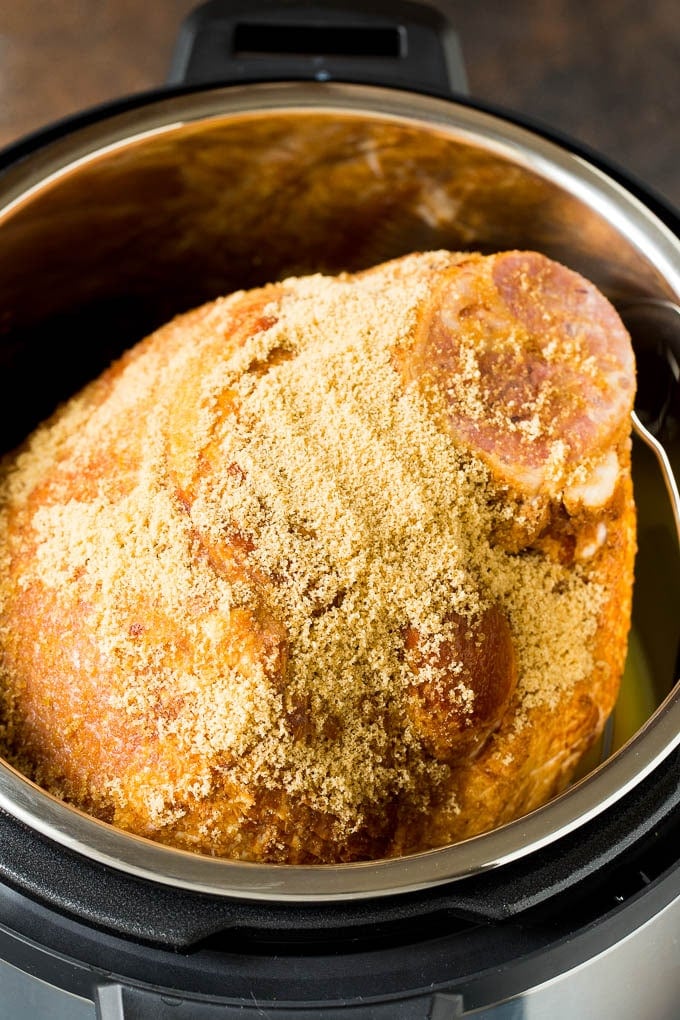 Pork covered in brown sugar in a pressure cooker.